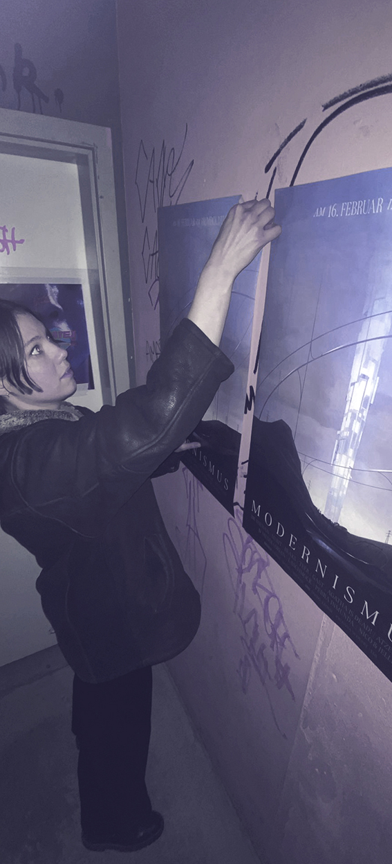Concept art poster showing a glowing LED tower in a futuristic desert landscape, Hannah Brückmann hanging the poster